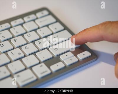 Keyboard with finger on the key Stock Photo