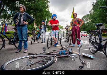 Climate activists are listening the speeches given at the KLM headquarters, during the Extinction Rebellion bicycle campaign against KLM support package, in Amsterdam, Netherlans on July 3, 2020. (Photo by Romy Arroyo Fernandez/NurPhoto) Stock Photo