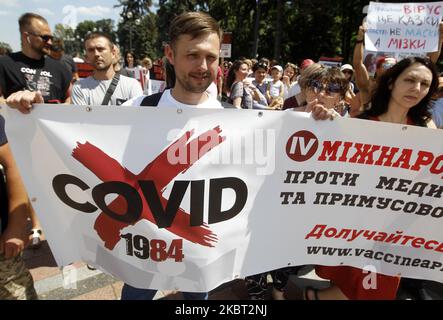 Anti-vaccination protesters hold placards during all-Ukrainian protest rally called 'For the family! For the rights of the child! Against medical tyranny' near the Ukrainian Parliament in center of Kyiv, Ukraine, on 03 July, 2020. The participants of 'Vaccination: Free Choice' movement and their supporters protest against a bill, the adoption of which, according to activists, can deprive parents of the right to denied medical interventions to children. ' (Photo by STR/NurPhoto) Stock Photo