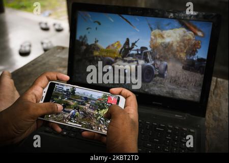 A boy plays PUBG at his home in Tehatta, Nadia, West Bengal, India on July 3, 2020. As Indians had to confine themselves to their homes due to the Coronavirush, many have turned to online games leading to a spike in app downloads and usage. India surfaced as the largest contributor in terms of the number of downloads for PlayerUnknown's Battlegrounds (PUBG). (Photo by Soumyabrata Roy/NurPhoto) Stock Photo