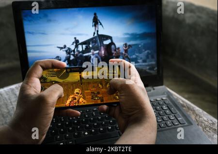 A boy plays PUBG at his home in Tehatta, Nadia, West Bengal, India on July 3, 2020. As Indians had to confine themselves to their homes due to the Coronavirush, many have turned to online games leading to a spike in app downloads and usage. India surfaced as the largest contributor in terms of the number of downloads for PlayerUnknown's Battlegrounds (PUBG). (Photo by Soumyabrata Roy/NurPhoto) Stock Photo