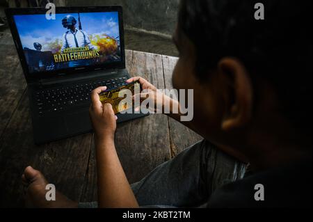 A boy plays PUBG at his home in Tehatta, Nadia, West Bengal, India on July 3, 2020. As Indians had to confine themselves to their homes due to the Coronavirush, many have turned to online games leading to a spike in app downloads and usage. India surfaced as the largest contributor in terms of the number of downloads for PlayerUnknown's Battlegrounds (PUBG). (Photo by Soumyabrata Roy/NurPhoto) Stock Photo