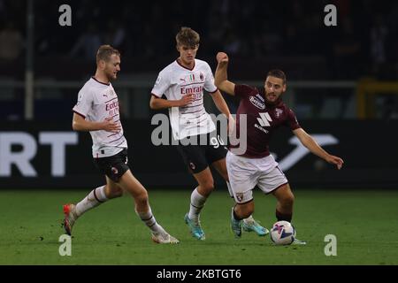 Turin, Italy, 30th October 2022. Tommaso Pobega and Charles De Ketelaere of AC Milan close in on Nikola Vlasic of Torino FC  during the Serie A match at Stadio Grande Torino, Turin. Picture credit should read: Jonathan Moscrop / Sportimage Stock Photo