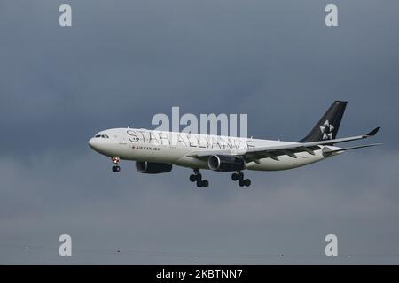 Air Canada Airbus A330 aircraft with Star Alliance aviation team special livery scheme appearance as seen arriving on final approach flying, landing and touching down on the runway at Amsterdam Schiphol AMS EHAM International Airport in the Netherlands, on July 2, 2020. The wide body airplane that fly transatlantic is an Airbus A330-300 with the registration C-GEGI, with 2x RR Rolls Royce jet engines. The plane is converted and is flying as Cargo Freight shipment from Canada to Europe and back with a configuration of 6 crew seats, because of the Covid-19 Coronavirus pandemic. (Photo by Nicolas Stock Photo