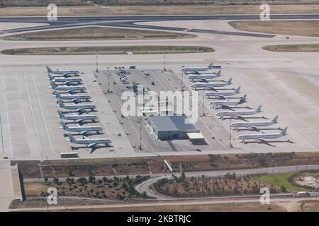 Grounded fleet of Aegean Airlines AEE, the flag carrier of Greece, as seen parked in the apron of Athens ATH LGAV International airport in the Greek Capital on July 7, 2020. A3 operates an all-Airbus fleet with A319, A320 mainly, A321 and new arrivals of modern and advanced Airbus A320NEO. The airplanes are parked with the engines covered as the airline temporarily ceased most of the operations due to the Coronavirus Covid-19 pandemic reduced traffic and travel restriction that the government imposed. Greece is restarting the summer season for tourism, one of the main income sources for the co Stock Photo