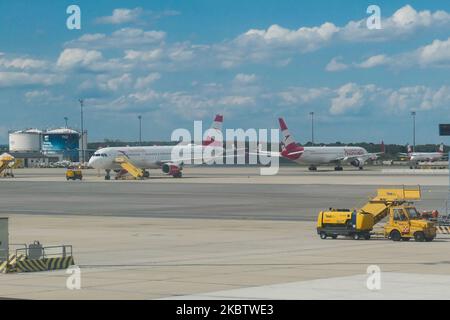 The grounded fleet of Austrian Airlines OS AUA, the flag carrier of Austria subsidiary of Lufthansa Group and member of Star Alliance as seen in Vienna International Airport Schwechat VIE, Austria, on July 15, 2020. Boeing and Airbus aircraft with the engines covered are seen parked on the apron tarmac during the Coronavirus Covid-19 Pandemic era as air travel traffic was reduced because of travel restrictions and traveling ban or lockdown quarantine measures. On July 1, Austria issues travel warning for six Balkan states countries, Serbia, Montenegro, Bosnia Herzegovina, North Macedonia, Alba Stock Photo