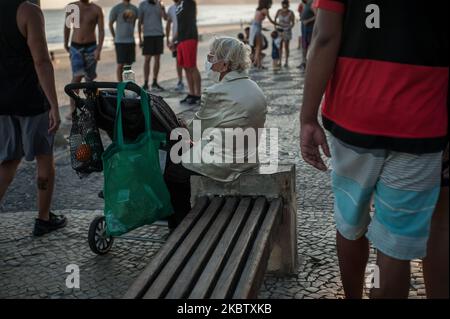 An Old Woman wearing protective mask is seen on the beach located in the south of the city of Rio de Janeiro, Brazil, on July 19, 2020. Local authorities start the 4th (fourth) of the 6 stages of the easing of social isolation (quarantine) or that allows some collective sports on the beach sand, except for the last few weeks. Rio de Janeiro surpassed the mark of 11,000 deaths caused by coronavirus (COVID-19) and more than 135,000 confirmed cases by the disease (Photo by Allan Carvalho/NurPhoto) Stock Photo