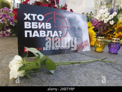 A poster with a photo of journalist Pavel Sheremet and reading like 'Who killed Pavel?' is seen during opening of a memorial at the site where he was killed by a car bomb four years ago, in Kyiv, Ukraine, on 20 July, 2020. Journalist Pavel Sheremet, 44, who worked in Ukrayinska Pravda online newspaper, died in a car explosion in downtown Kyiv on 20 July 2016. On 12 December , 2019 the Interior Minister Arsen Avakov said that the National Police investigators have detained suspected in the murder of journalist Pavel Sheremet. (Photo by STR/NurPhoto) Stock Photo