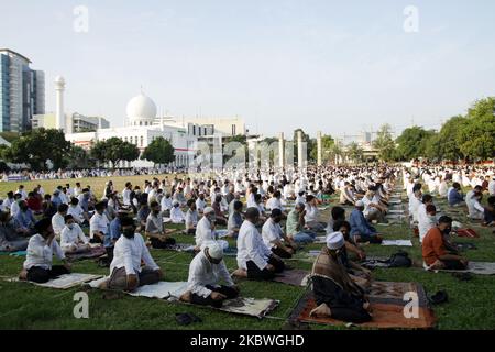 Indonesian muslims wearing protective face shield and mask, and keep social distancing as they attend the Eid Al Adha prayer during the coronavirus pandemic at Al Azhar mosque in Jakarta, Indonesia on July 31, 2020. Indonesian government allows muslims to holding the Eid Al Adha prayer with strict health protocols, except in areas that are still designated as Covid-19 red zones. (Photo by Aditya Irawan/NurPhoto) Stock Photo