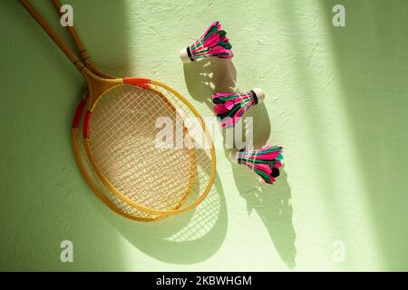 badminton rackets and shuttlecock on the green table. Flat lay Stock Photo
