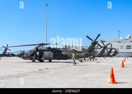 United States of America Army Troops assembly and fix their helicopters after unloading them from ARC ship at the port of Alexandroupoli. Troops of the 101st Airborne Combat Aviation in uniform on duty working on the helicopters and wearing facemasks as safety preventive measures against the spread of Coronavirus Covid-19 Pandemic outbreak. The 101 CAB Brigade of the army of the USA arrives at the port of Alexandroupolis in Greece to deploy soldiers, manpower, troops, vehicles and helicopters for Atlantic Resolve 2020 NATO military exercise. On July 23, 2020 in Alexandroupoli, Greece. (Photo b Stock Photo