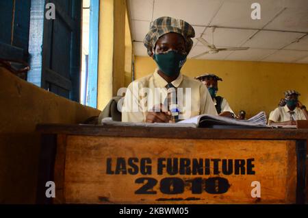 High School female students wears a face mask while they reads in a classroom at Girls Junior Grammar School, S.W, Ikoyi, Lagos on August 3, 2020 on the first day after resumption of classes after the COVID-19 coronavirus lockdown. (Photo by Olukayode Jaiyeola/NurPhoto) Stock Photo