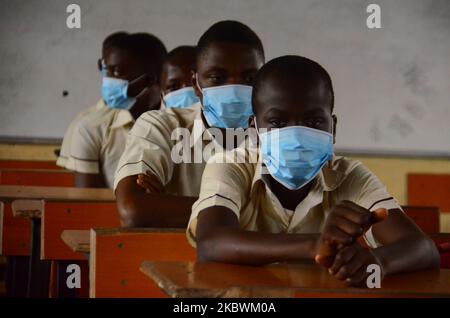 High School female students wears a face mask while they reads in a classroom at Ireti Junior Grammar Schol, Ikoyi, Lagos on August 3, 2020 on the first day after resumption of classes after the COVID-19 coronavirus lockdown. (Photo by Olukayode Jaiyeola/NurPhoto) Stock Photo