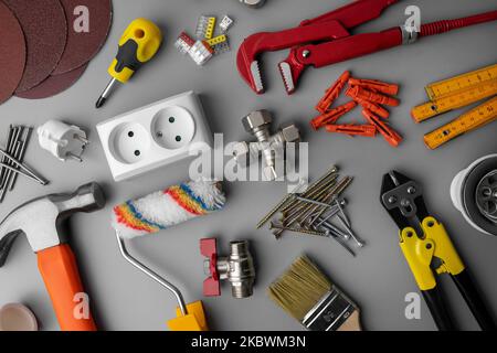household hardware items. home improvement and repair tools on gray background. top view Stock Photo