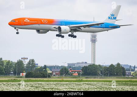 KLM Royal Dutch Airlines Boeing 777 passenger aircraft as seen flying on final approach for landing, touch down, breaking and taxiing at Polderbaan runway in Amsterdam Schiphol International Airport in the Netherlands on July 2, 2020. The dual color wide-body long haul airliner is painted in Orange and Classic Blue in the special scheme livery colors called Orange Pride #OrangePride, the Boeing B777 or Boeing 777-306(ER) airplane has the registration PH-BVA and the name Nationaal Park De Hoge Veluwe / De Hoge Veluwe National Park. KLM legally Koninklijke Luchtvaart Maatschappij N.V. is the Dut Stock Photo