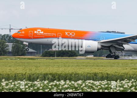 KLM Royal Dutch Airlines Boeing 777 passenger aircraft as seen flying on final approach for landing, touch down, breaking and taxiing at Polderbaan runway in Amsterdam Schiphol International Airport in the Netherlands on July 2, 2020. The dual color wide-body long haul airliner is painted in Orange and Classic Blue in the special scheme livery colors called Orange Pride #OrangePride, the Boeing B777 or Boeing 777-306(ER) airplane has the registration PH-BVA and the name Nationaal Park De Hoge Veluwe / De Hoge Veluwe National Park. KLM legally Koninklijke Luchtvaart Maatschappij N.V. is the Dut Stock Photo