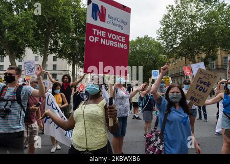 NHS staff demonstrate outside Downing Street during a protest march from St James's Park to Parliament Square through central London to demand 15% pay rise for NHS workers on 08 August, 2020 in London, England. Protesters demonstrate against not being included in the government's pay deal for 900,000 public sector workers amid the sacrifices and hardship experienced during the coronavirus pandemic. (Photo by WIktor Szymanowicz/NurPhoto) Stock Photo