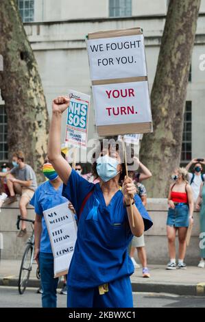 NHS staff demonstrate outside Downing Street during a protest march from St James's Park to Parliament Square through central London to demand 15% pay rise for NHS workers on 08 August, 2020 in London, England. Protesters demonstrate against not being included in the government's pay deal for 900,000 public sector workers amid the sacrifices and hardship experienced during the coronavirus pandemic. (Photo by WIktor Szymanowicz/NurPhoto) Stock Photo