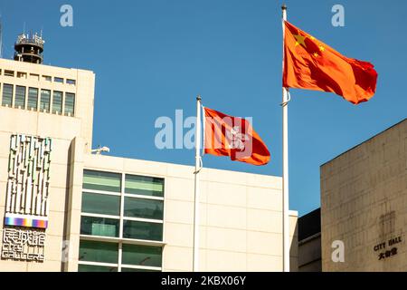 People Republic of China (PRC) and the Hong Kong SAR flag fly outside of City Hall and the City Gallery in Hong Kong, China, on August 8, 2020. (Photo by Simon Jankowski/NurPhoto) Stock Photo