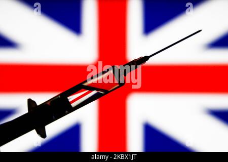 In this illustration photo medical syringe is seen with British flag in the background. Picture taken in Krakow, Poland on August 11, 2020. (Photo illustration by Jakub Porzycki/NurPhoto) Stock Photo