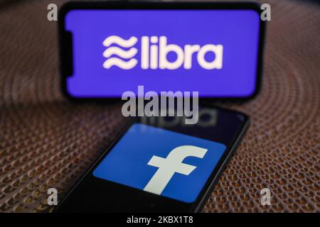 Logos of Facebook and Libra are seen displayed on a smartphones in this illustration photo taken in Krakow, Poland on August 11, 2020. (Photo Illustration by Jakub Porzycki/NurPhoto) Stock Photo