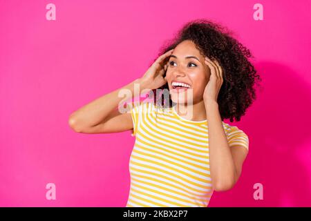 Close up photo of nice young girl look up empty space impressed excited wear trendy striped outfit isolated on shine pink color background Stock Photo