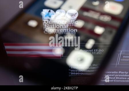 The logo for the Democratic Convention is seen reflected on the screen of a phone, in a photo-illustration captured on August 12, 2020 in Philadelphia, PA, USA. Due to the Covid-19 Pandemic the Democratic National Convention is scheduled for next week and will take part online, with from Vice-President Joe Biden and Sen. Kamala Harris expected to accept the nomination for the ticket in 2020 U.S. Presidential Elections. (Photo by Bastiaan Slabbers/NurPhoto) Stock Photo