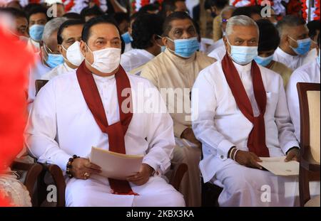 Sri Lankan prime minister Mahinda Rajapaksa and his elder brother Chamal Rajapaksa wearing face masks wait for the arrival of their brother Gotabaya Rajapaksa(unseen) during an event for the swearing in of the new cabinet ministers at the historical ''Magul Maduwa''/ ''Assembly Hall'' situated at the Temple of the Sacred Tooth Relic where the ancient Sri Lankan kings met their ministers and carried out daily administrative tasks at Kandy, Sri Lanka 12 August 2020. (Photo by Tharaka Basnayaka/NurPhoto) Stock Photo