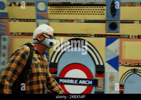 A man wearing a face mask, currently mandated on public transport, walks along a platform at Marble Arch station on the Central line in London, England, on August 14, 2020. Passenger numbers on the London Underground remain well below pre-pandemic levels as the city continues its hesitant emergence from the coronavirus lockdown, with covid-19 fears still keeping many from using public transport. (Photo by David Cliff/NurPhoto) Stock Photo