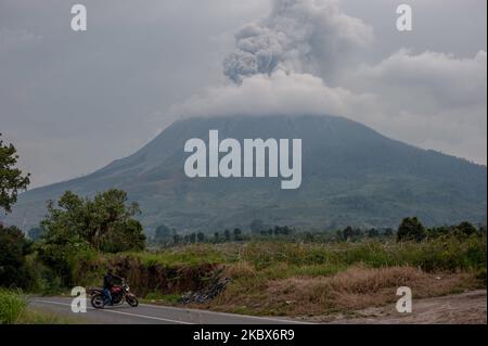 A man passes around the Sinabung volcano when the eruption occurred on August 15, 2020, in Karo, North Sumatra, Indonesia. Several villages and agricultural land around Mount Sinabung were hit by volcanic ash and respiratory problems. (Photo by Muhammad Fauzy/NurPhoto) Stock Photo