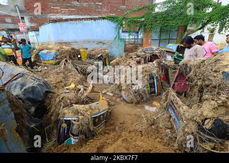 Vehicles submerged in mud as landslide brought in sand to low laying ...