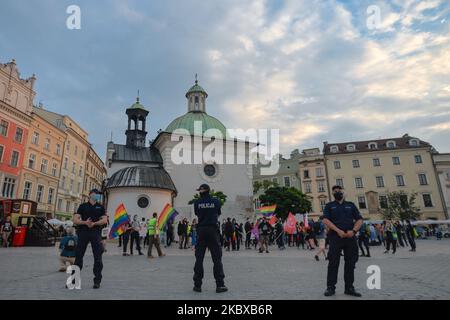 Members of the Police separate two different protests in Krakow.. Far Right nationalists and Pro-Life activists organised a protest against the LGBT next to the Adam Mickiewicz monument in Krakow's Main Market Square. On the opposite side of the square, LGBT activists and antifascists organised a counter protest. On August 19, 2020, in Krakow, lesser Poland Voivodeship, Poland. (Photo by Artur Widak/NurPhoto) Stock Photo