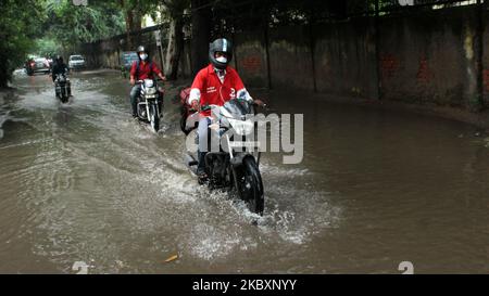 A motor cyclist passes through a waterlogged stretch near Delhi Police Headquarters at ITO, Vikas Marg on August 28, 2020 in New Delhi, India. Heavy rain in the national capital brought down the temperature but led to traffic jams and flooding in parts of the city. The downpour also brought relief from the intense humidity of the past few days. (Photo by Mayank Makhija/NurPhoto) Stock Photo