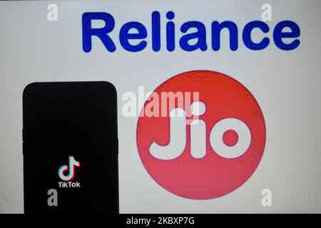 A photo Illustration of Tiktok app on mobile device and Reliance Jio logo in the background in Kolkata, India, on August 29, 2020. Reliance Jio is in the process to buy the India operation of Tiktok, the popular Chinese video sharing app which was banned by the Indian government owing to the border clashes against China in month of May-June. (Photo Illustration by Debarchan Chatterjee/NurPhoto) Stock Photo