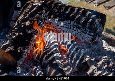 A Burning wood to make embers on a grill Stock Photo