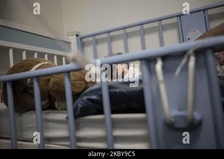 Iranian 7-year-old boy, Mohammad Amin, who is infected by the new coronavirus disease, wearing a protective face mask as he lies on a hospital bed in the COVID-19 section of the Ali Asghar children’s hospital in northern Tehran on September 6, 2020. Iranians thought that children do not infect with the COVID-19 but, they realized that Children of all ages become infected with the new coronavirus disease but, most of them who are infected won't become as sick as adults. (Photo by Morteza Nikoubazl/NurPhoto) Stock Photo