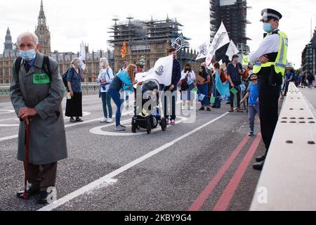 An elderly member of climate change activist movement Extinction Rebellion takes part in a march in protest at ecological destruction of the world's oceans crossing Westminster Bridge in London, England, on September 6, 2020. The group launched a new series of demonstrations in the city on Monday, with more scheduled for the week ahead, after a hiatus in its protest actions during the height of the coronavirus crisis. (Photo by David Cliff/NurPhoto) Stock Photo