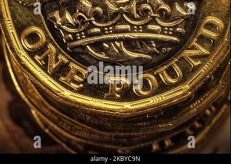 Close up detail of British UK One pound Coin on top of a pile of coins. The new bi-metallic one pound coin was first introduced in 2017. Stock Photo