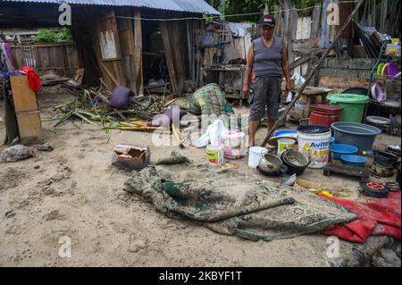 A mother is near her house which was damaged by floods in Oloboju Village, Sigi Regency, Central Sulawesi Province, Indonesia on September 9, 2020. Although it did not cause any casualties, the sudden flood due to the high intensity of rain on Tuesday (9/8/2020) evening damaged at least six houses in the village. Sigi Regency is an area located south of Palu City, the capital of Central Sulawesi province. Almost every year in the rainy season, this area is always hit by floods. (Photo by Basri Marzuki/NurPhoto) Stock Photo