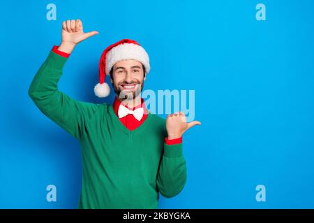 Portrait of positive satisfied person toothy smile indicate thumb fingers empty space isolated on blue color background Stock Photo