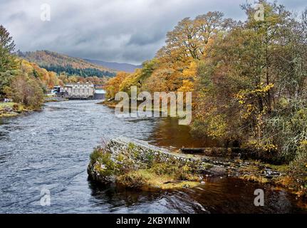 Pitlochry Perthshire Scotland river Tummel and the dam seen from the iron suspension bridge with trees in autumnal colours Stock Photo
