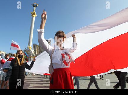People hold historical white-red-white flags of Belarus during a rally of solidarity with Belarusian protests on the Independence Square in Kyiv, Ukraine on 20 September 2020. Belarusians who live in Ukraine, and Ukrainian activists who support them gathered for their rally in support of the opposition protests in Belarus against presidential election results. (Photo by STR/NurPhoto) Stock Photo