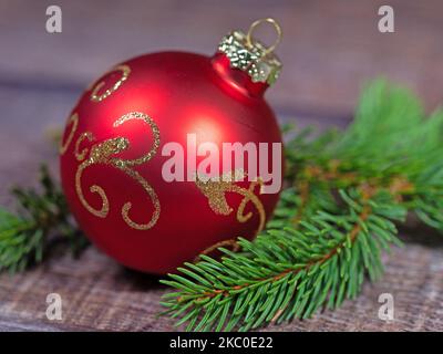 Red Christmas tree ball on spruce branch Stock Photo