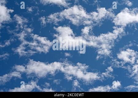 Small fleecy clouds, cirrocumulus, against a blue sky Stock Photo