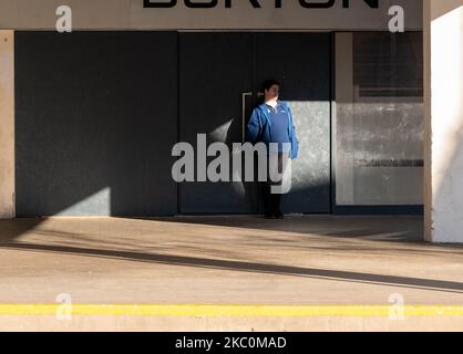 3 November 2022. Peterhead, Aberdeenshire, Scotland. This is a woman in the shadows of the day having a cigarette. Stock Photo