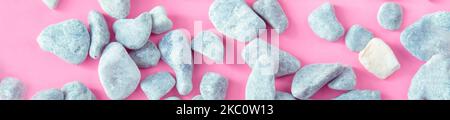 banner gray stones on a pale pink background. Ultimate Gray stones on a pink color. Pastel texture. Delicate colors Stock Photo