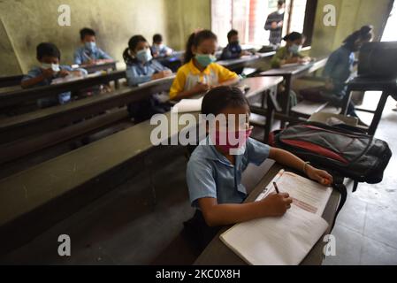 Primary School students of Prabhat Madhyamik Vidhyalaya, a government based school taking their classes after six months of complete closure due to COVID-19 pandemic fear at Thankot, Kathmandu, Nepal on September 30, 2020. Schools started resuming its classes with a proper safety measures and standard guidelines concerned towards local government's decisions. (Photo by Narayan Maharjan/NurPhoto) Stock Photo