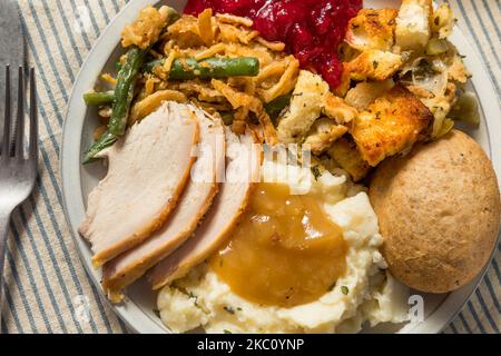 Homemade Thanksgiving Turkey Dinner with Potatoes Gravy Cranberry and Beans Stock Photo