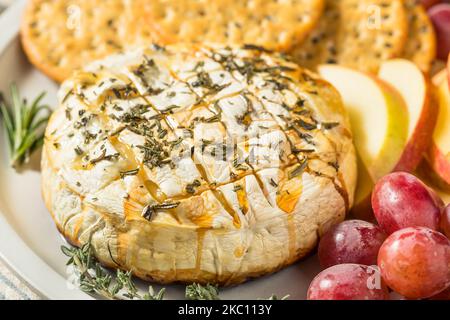 Homemade Baked Brie Appetizer with Apples and Crackers Stock Photo