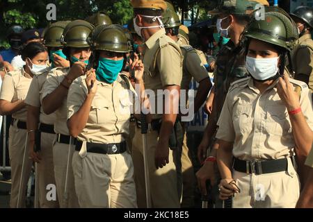 Indian women Police Warring Face Mask at front of NRS Hospital , Bharatiya Janata Party (BJP) workers agitation at front of NRS Hospital,Massive police deployment was seen at the hospital as BJP supporters raised slogans, demanding justice for the slain BJP leader Manish Shukla. BJP Supporters in front of the NRS hospital when the body was brought for for post-mortem in the afternoon.They broke police barricades and got engaged in a scuffle with police officials.The police failed to control the situation initially in Kolkata on October 05,2020. BJP leader Manish Shukla was shot dead on Sunday  Stock Photo